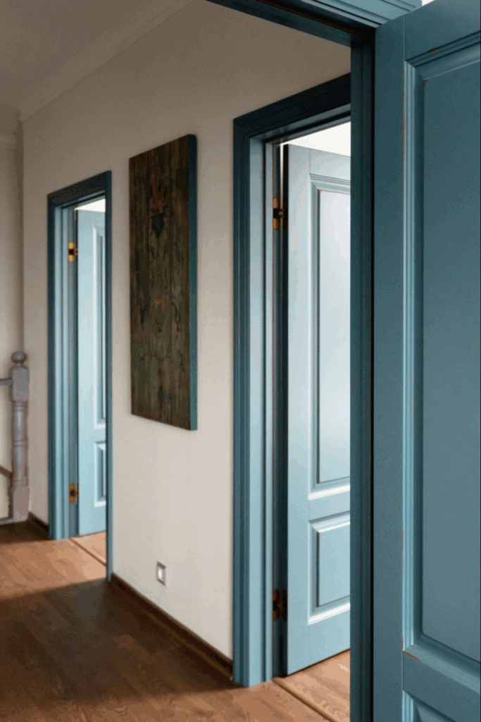 Modern hallway with blue interior doors and wood flooring